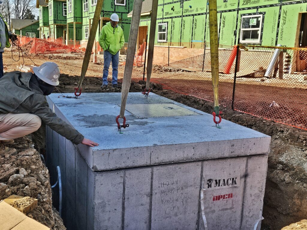precast concrete utility vault being placed on jobsite